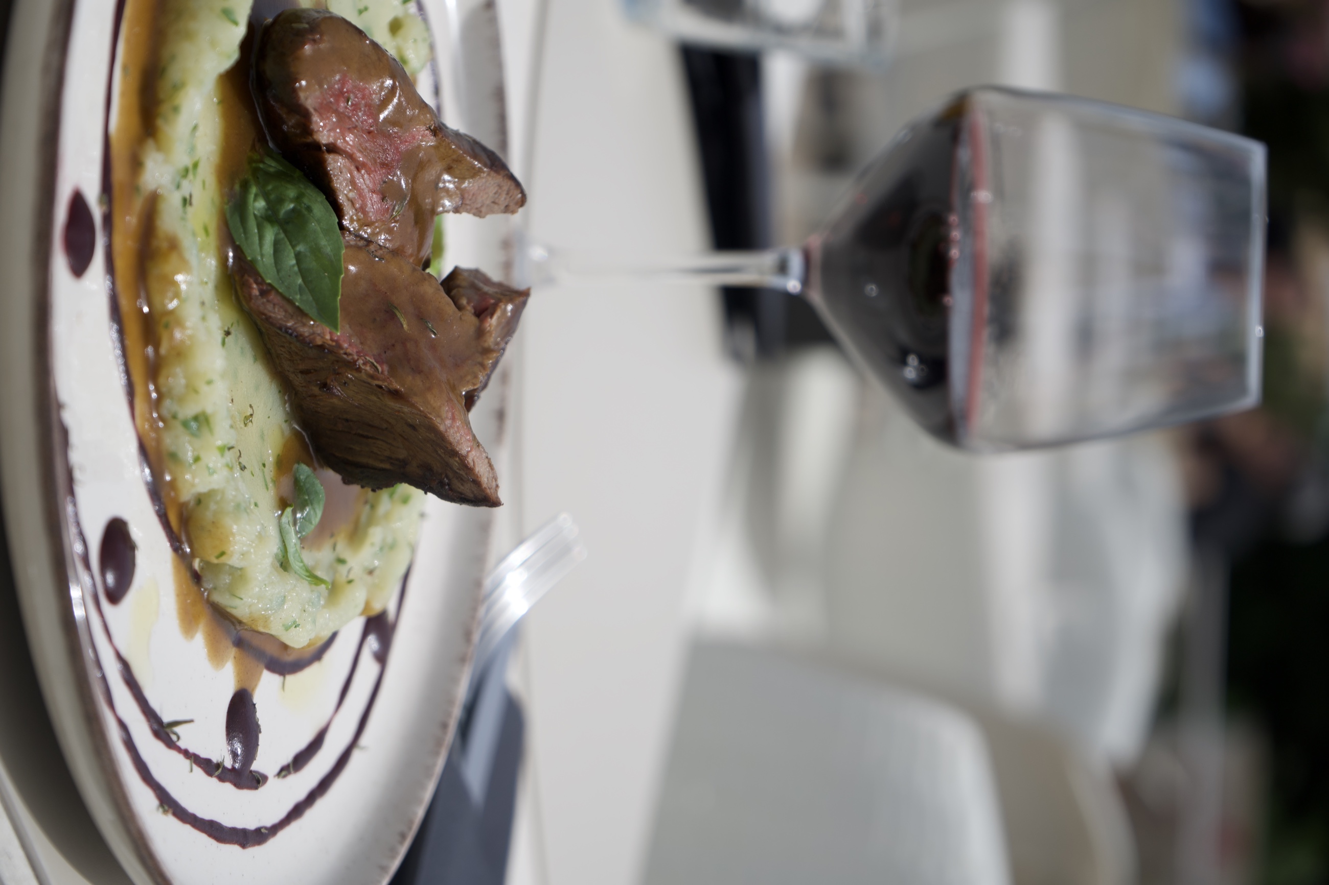 Ein Gericht des Bistrot La Blanca mit einem Glas Wein